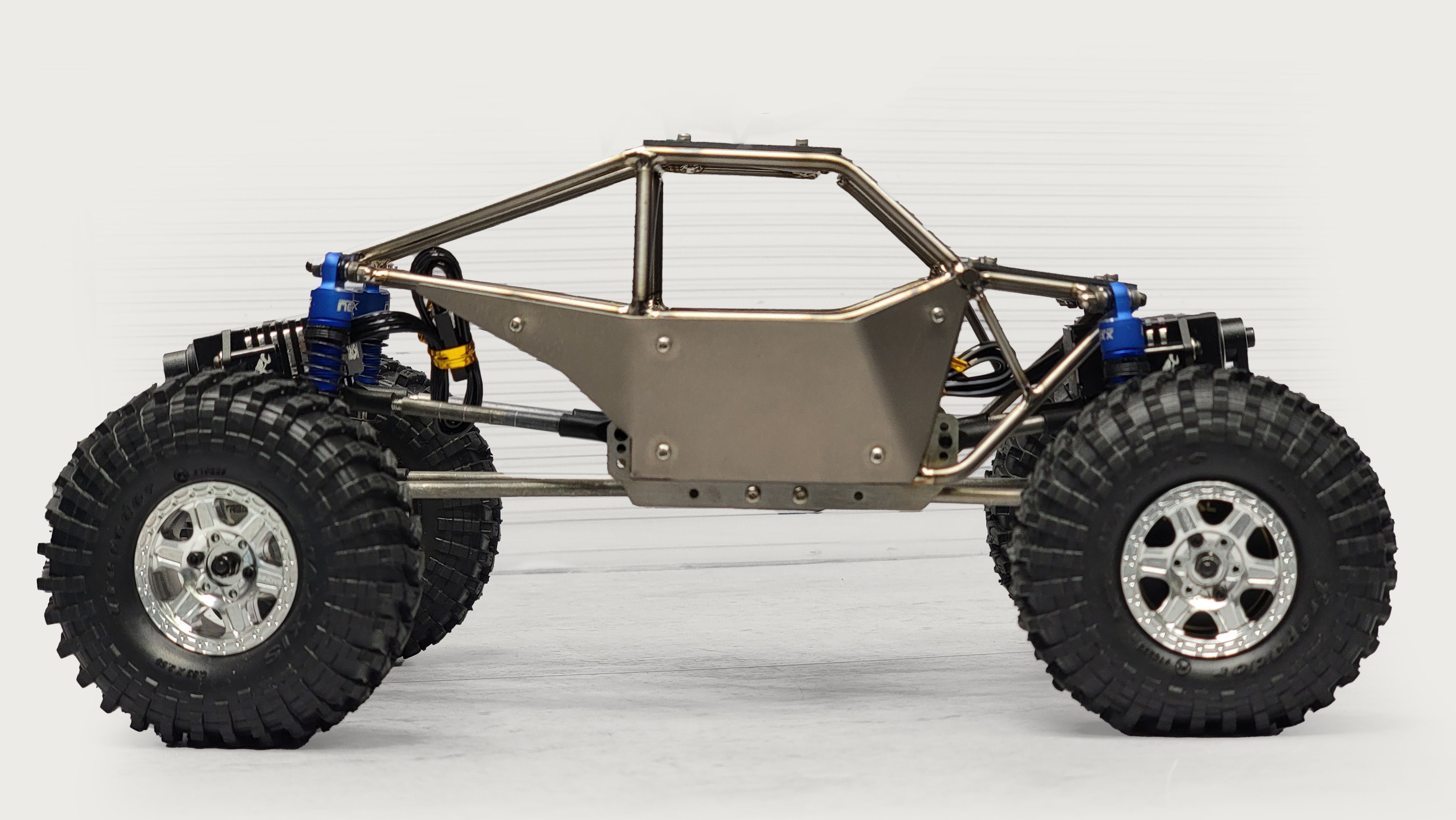 Custom RC rock crawler with titanium chassis and upgraded suspension by RCSTEVE, built for durability, articulation, and high-performance off-road control.