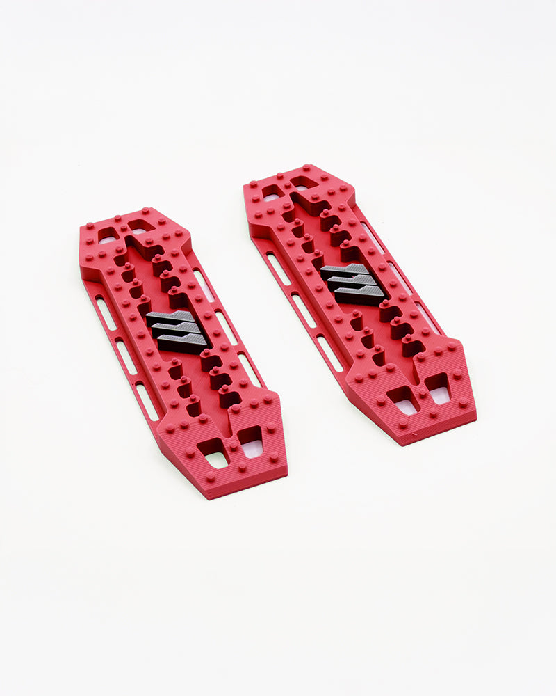 Red 1/10 RC crawler traction boards with molded tread detail for scale realism and performance.