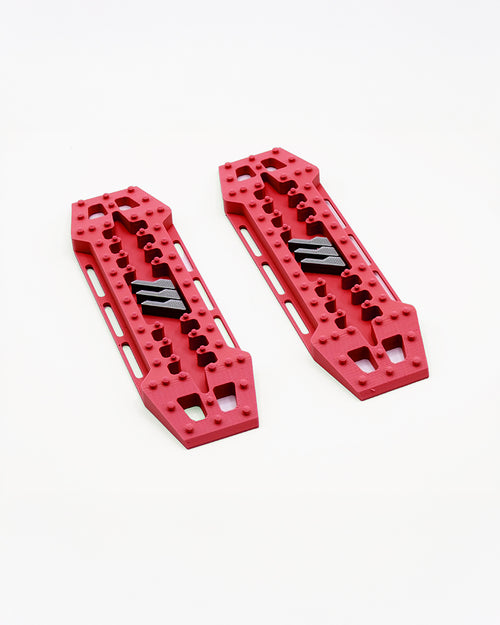 Red 1/10 RC crawler traction boards with molded tread detail for scale realism and performance.