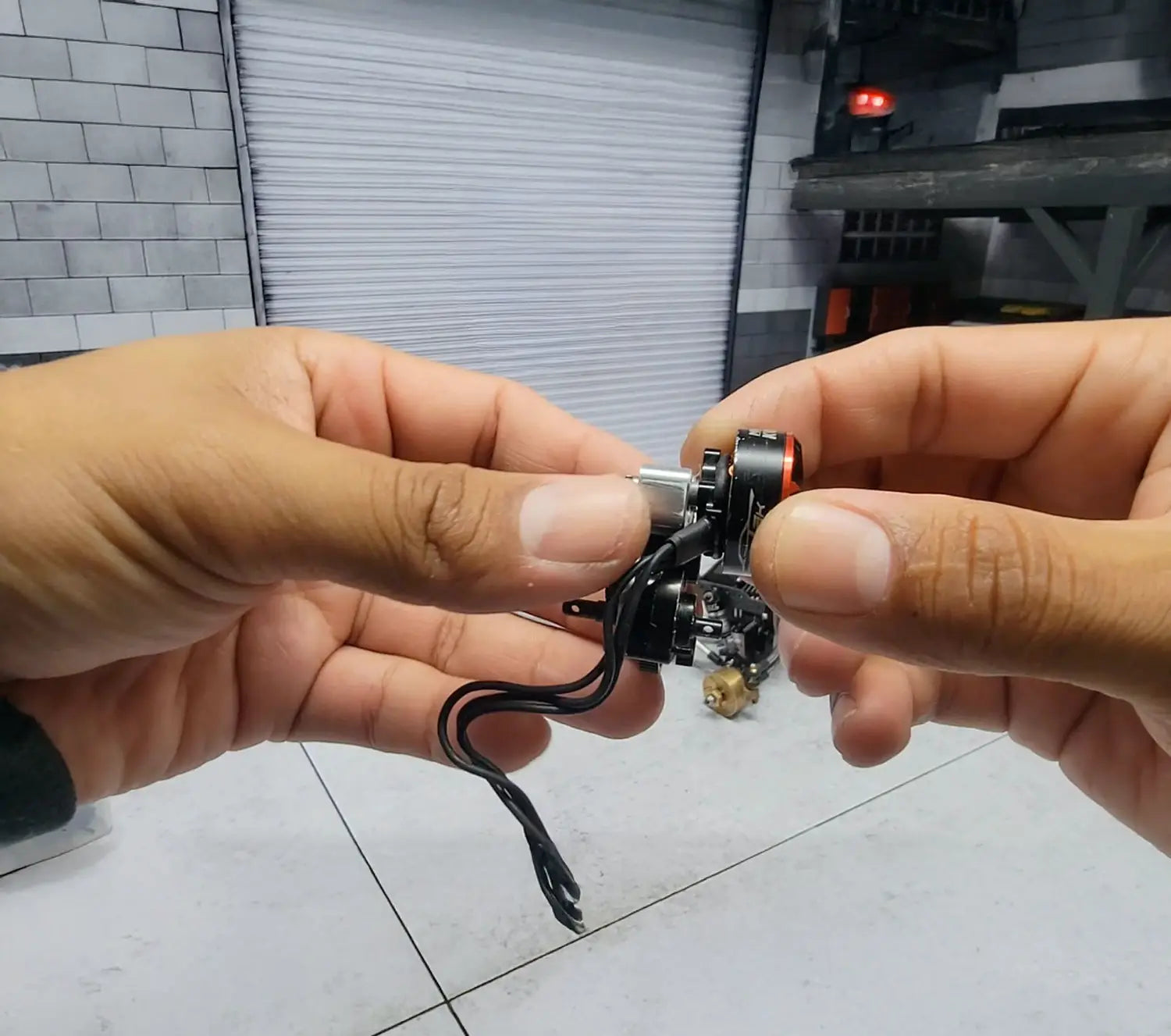 Close-up of hands assembling RC motor and transmission, highlighting RCSTEVE attention to detail and expert crawler craftsmanship.